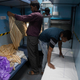Railway employees fixing a mosquito net in the converted quarantine wards.